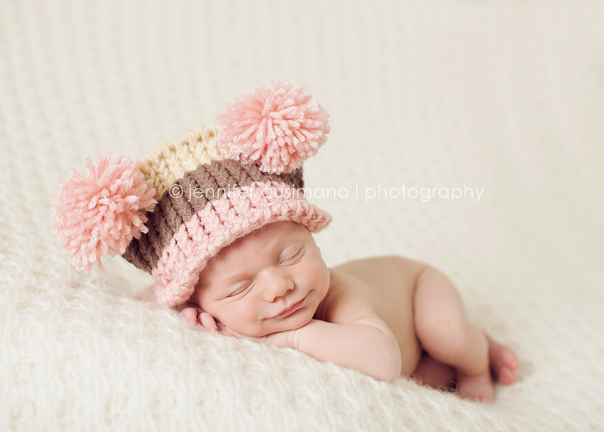 smiling baby with pink hat