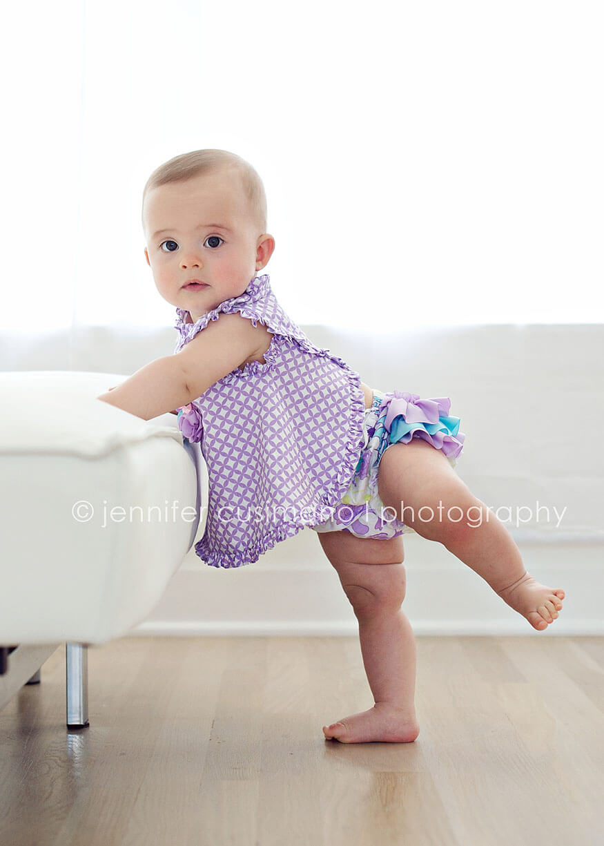 baby girl standing on one foot backlit image