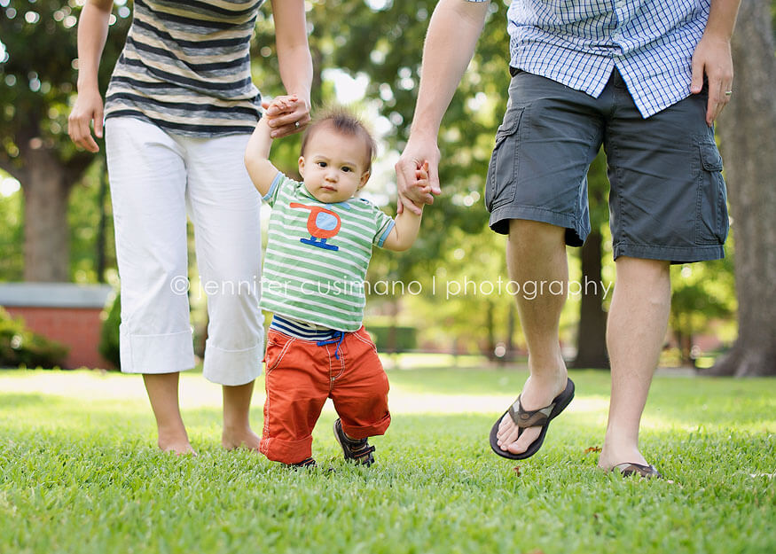 baby boy running with parents in Houston, TX with mini boden clothes