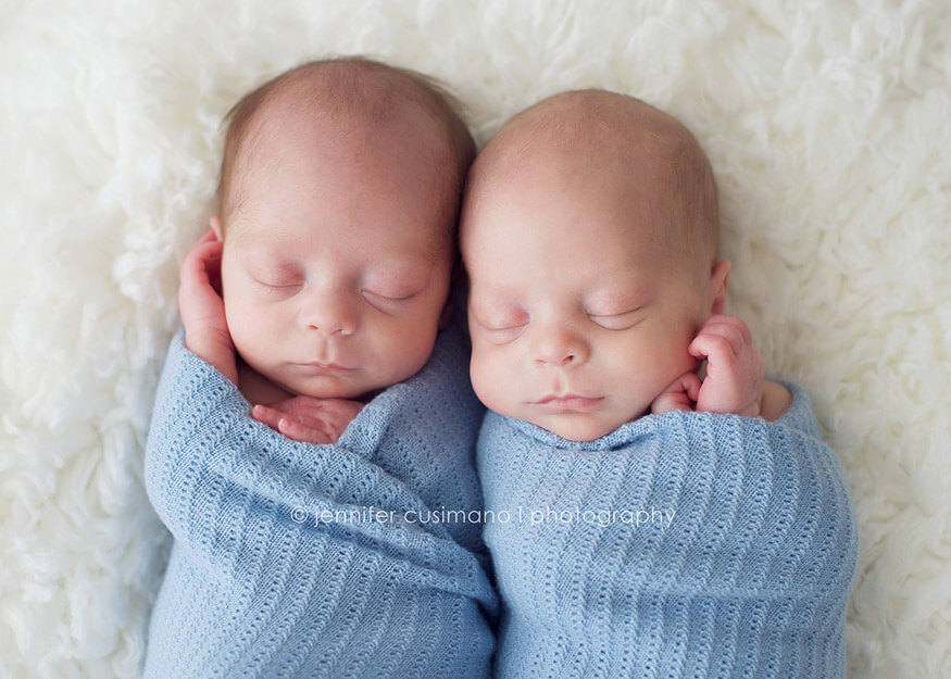 twin baby boys swaddled in blue blankets