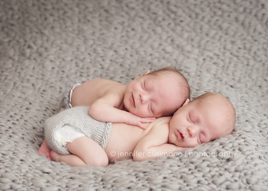 newborn baby boys on gray blanket